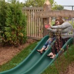 adult and child on natural slide
