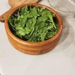 Chopped greens in wooden bowl